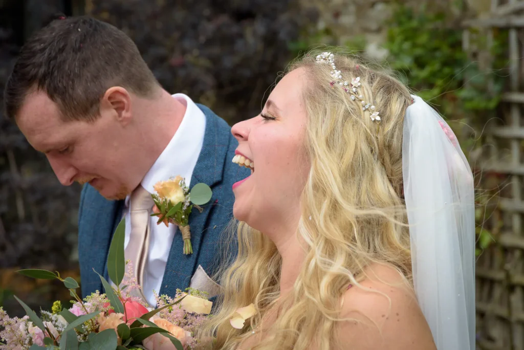 A happy couple laughing on their wedding day