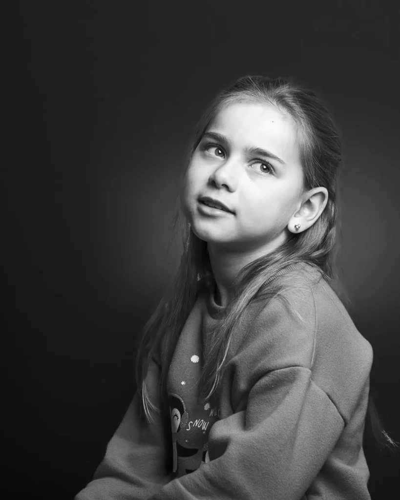 Nastya Photo Shoot-7324 Studio black & white image - half body shot of a young girl with soft lighting