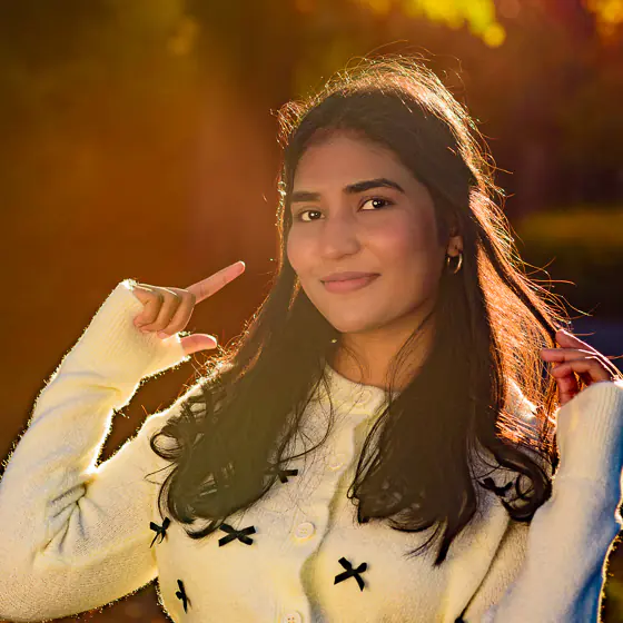 Hina-38-square 560px-1 Outdoor headshot of smiling young woman during golden hour — personal branding client photographed by Dick Lloyd in Harrogate