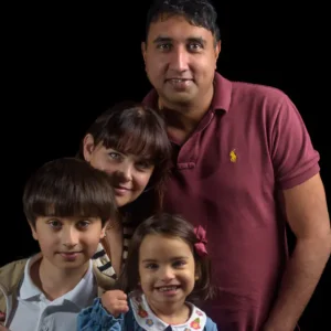 Varghese Family - 3196 square 560px-1 Photography Portfolio Yorkshire - Relaxed family portrait taken on location with black background effect, by Yorkshire photographer Dick Lloyd