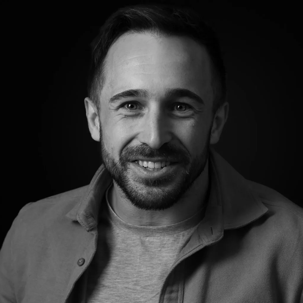 Corporate headshots in Harrogate - man casually dressed - monochrome with a black background - moody feeling