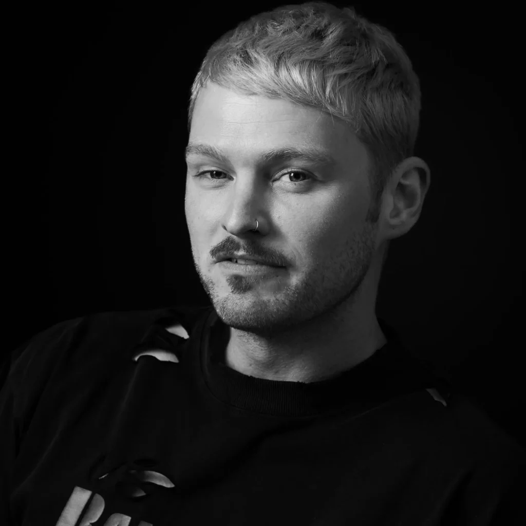 Corporate headshots in Harrogate - man casually dressed in a black T shirt - monochrome with black background