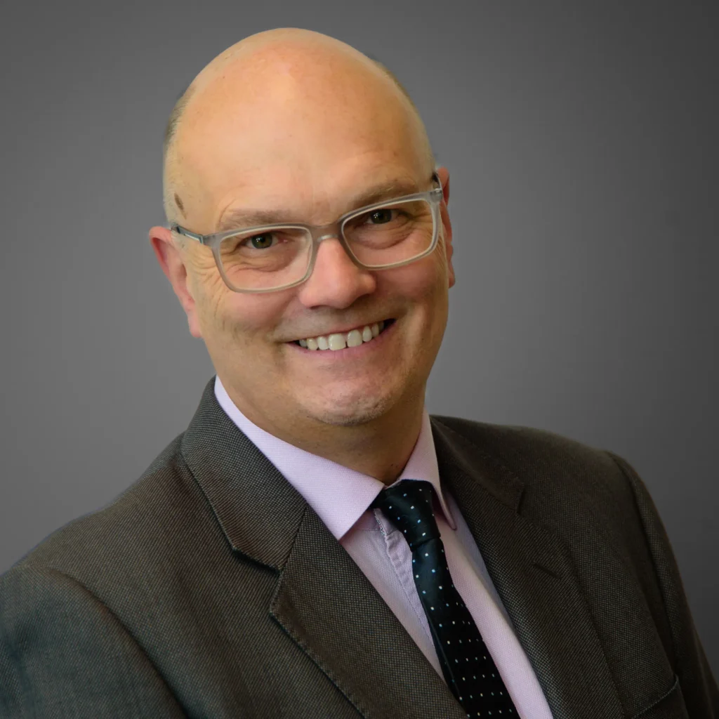 Businessman in suit and tie - headshot with grey background