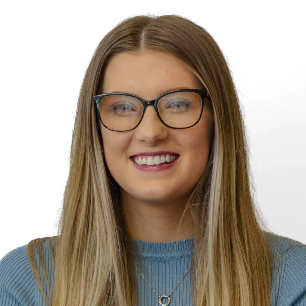Young woman in blue top with glasses - headshot with white background