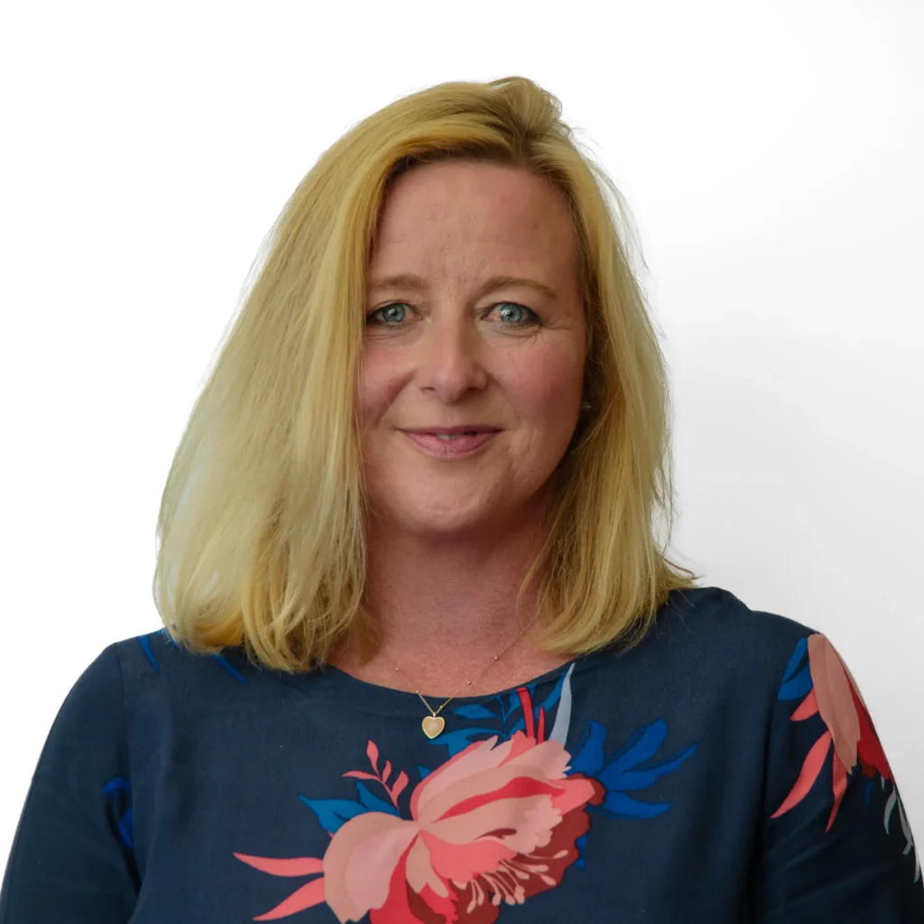 Woman in floral dress - headshot with hitebackground Professional business headshot with a natural, confident expression