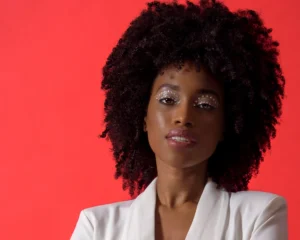 Headshot of female model with a red background by Dick Lloyd Photography