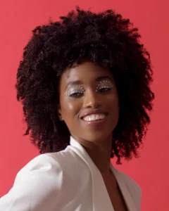 Headshot of model in white jacket with red background by Dick Lloyd Photography