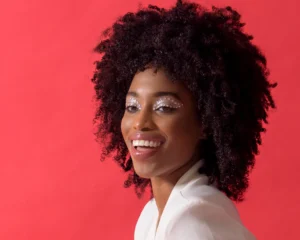 Headshot of confident model miling with red background by Dick Lloyd Photography