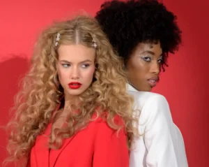 Two female models in bold red and white styling – half body portfolio shot for acting and modelling