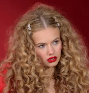 Headshot of a female model with a red background by Dick Lloyd Photography