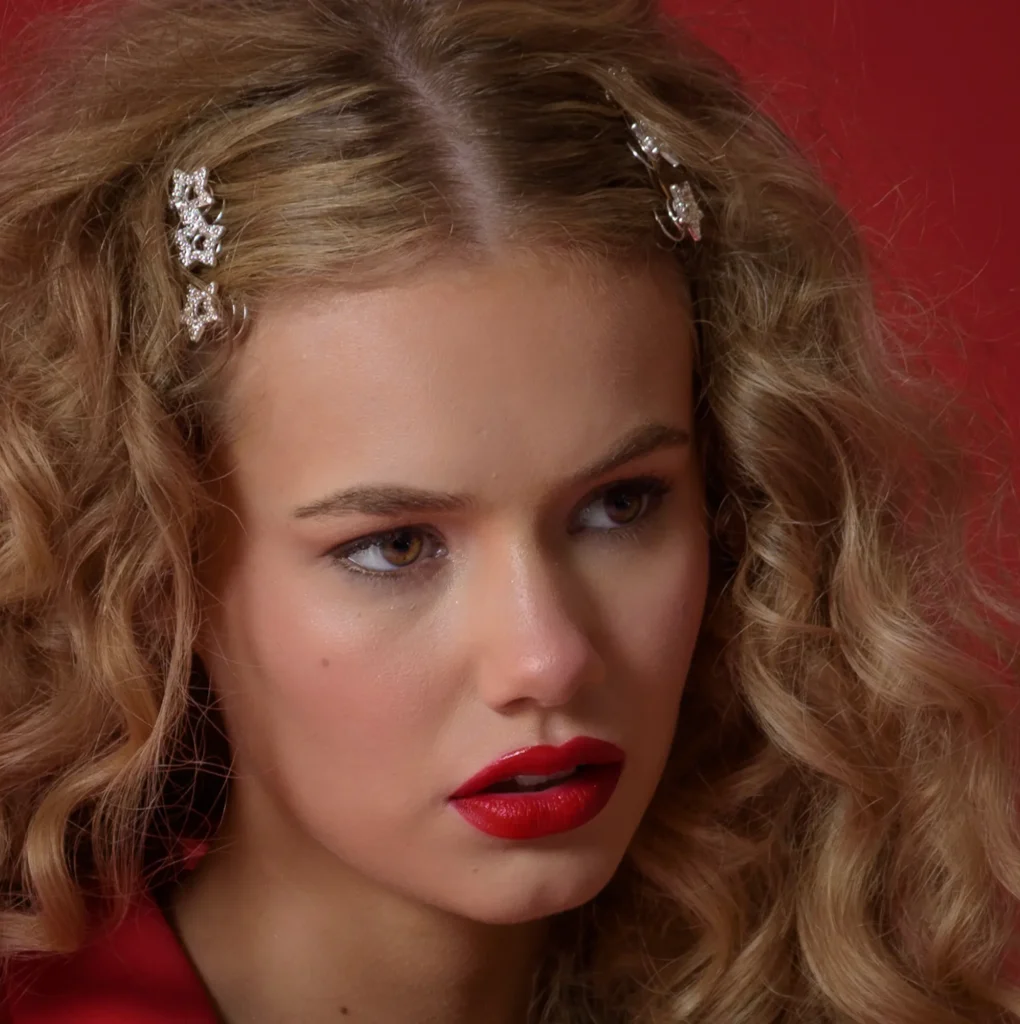 Actress headshot with natural expression, blonde performer in red jacket — Harrogate studio, Dick Lloyd Photography.