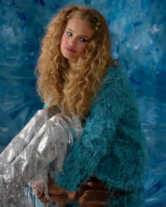 Full body shot of a female model with a blue background by Dick Lloy Photography