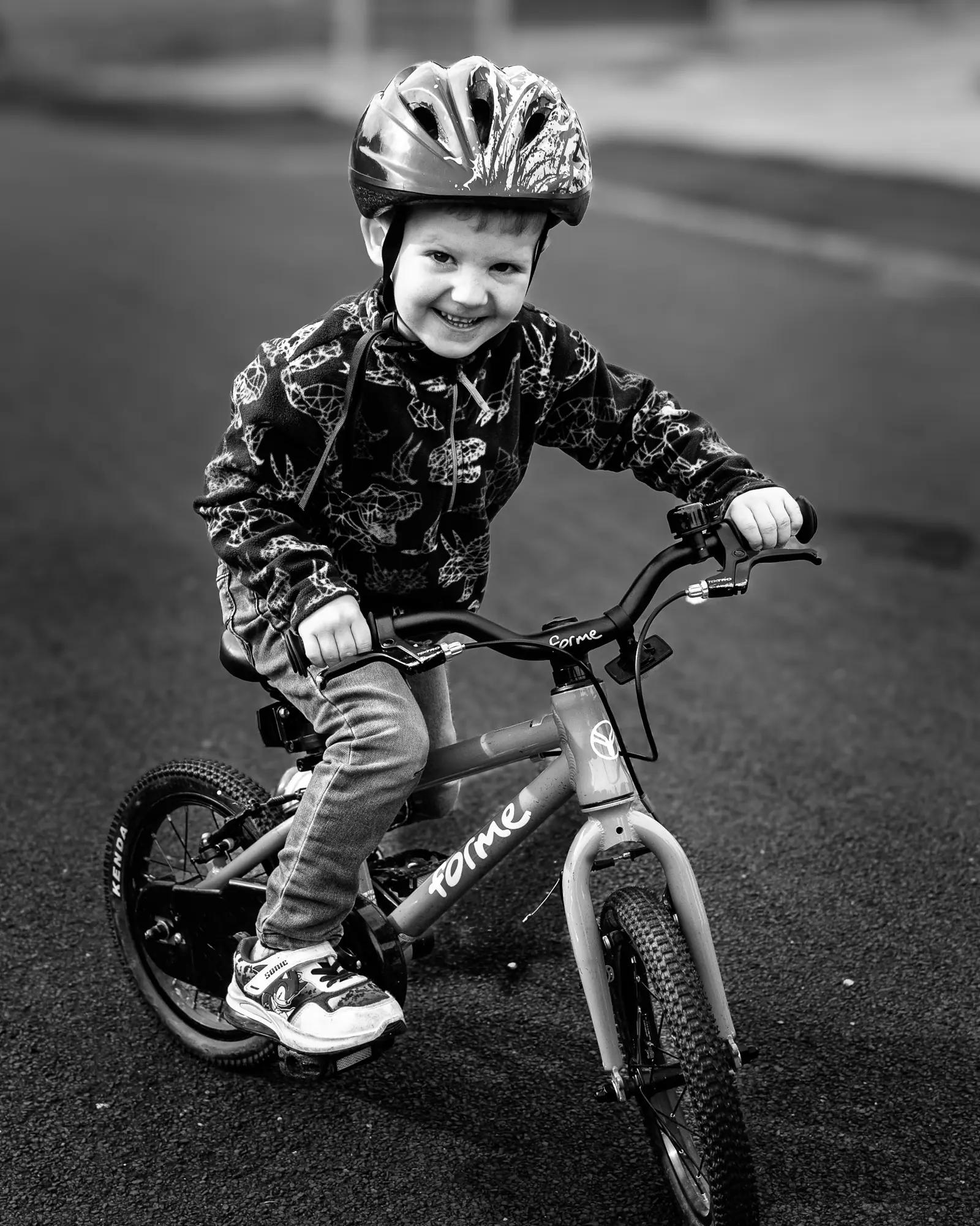 Toddler riding his bike black & white
