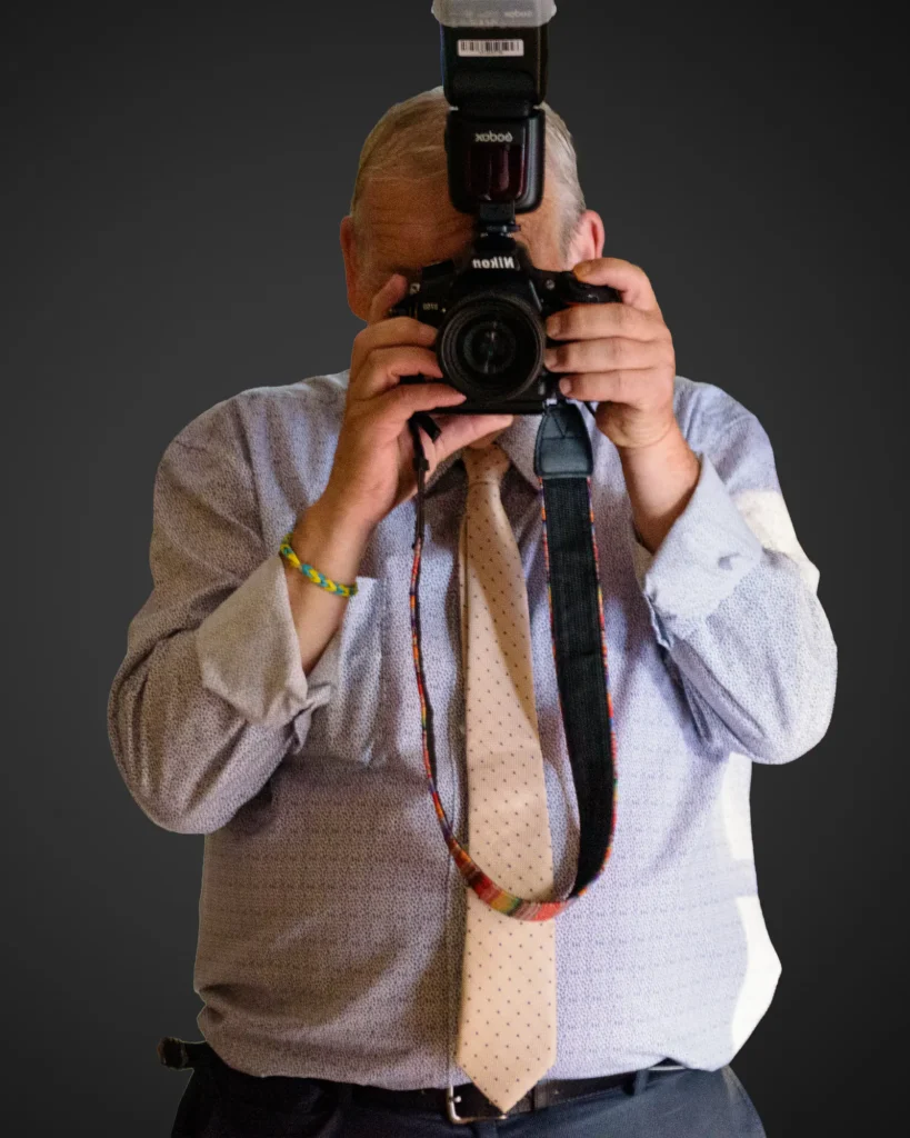 Dick Lloyd with his camera 4x5 portrait- Portrait of photographer Dick Lloyd holding a camera in the studio.