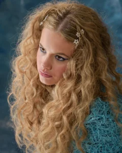 Headshot of a blonde female model looking to the side, blue background by Dick Lloyd Photography