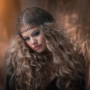 Half-body shot of a blonde female model copper-toned bakground by Dick Lloyd Photography