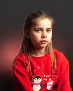 Studio portrait of a young girl with a red jumper