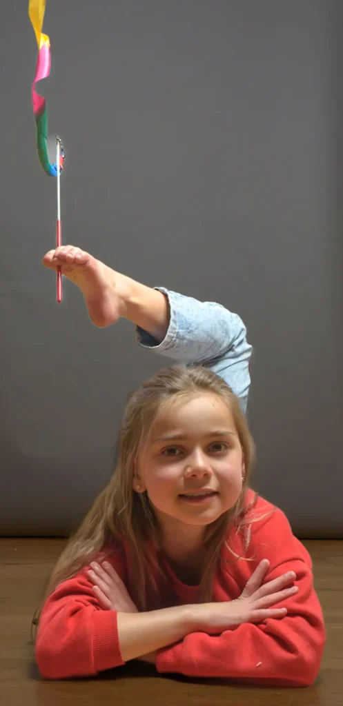 Nastya Studio Shoot-52 Studio portrait of a young girl performing a gymnastic exercise with a coloured ribbon.