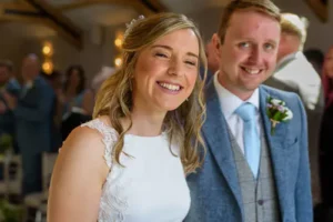Bride and groom smiling as they walk back up the aisle after the ceremony.