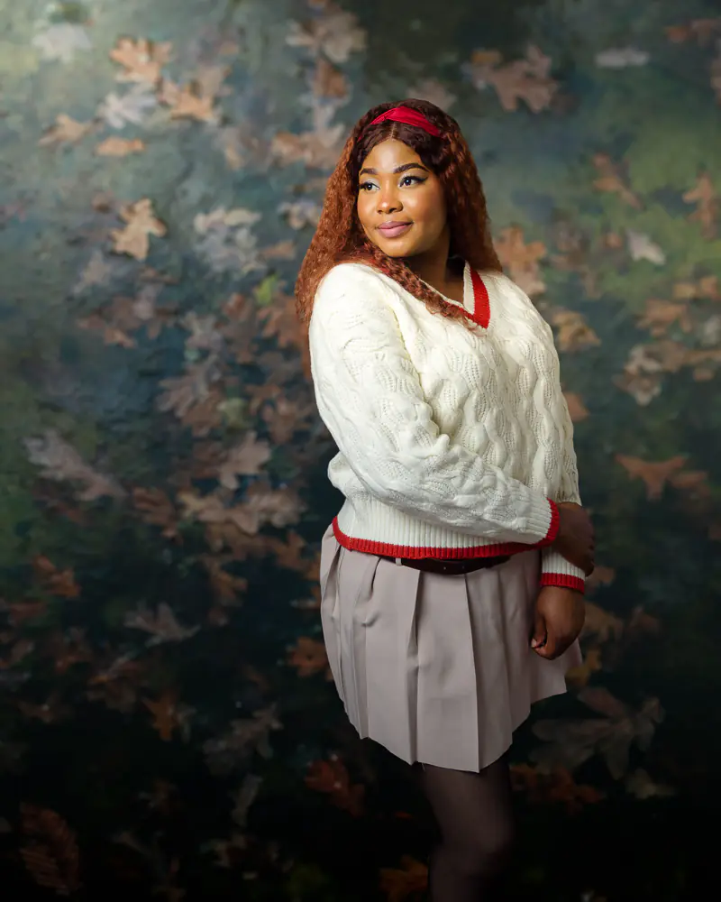 Queenie-9907-Edit-autumn-leaves-green-blue-bg Portrait photographer Harrogate capturing a second outfit with autumn toned studio backdrop