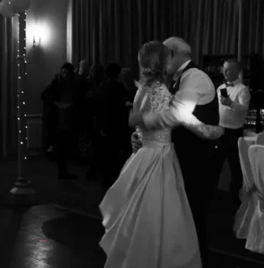 Bride and groom dancing together during the evening reception.