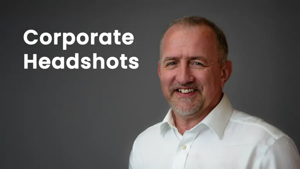 Professional corporate headshot of a businessman on a clean grey background